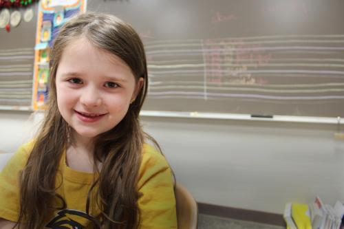 Avery - young girl sitting in a classroom